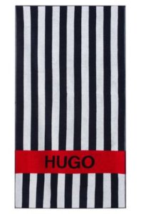 Hugo - Serviette de plage en molleton de coton à rayures avec logo contrastant