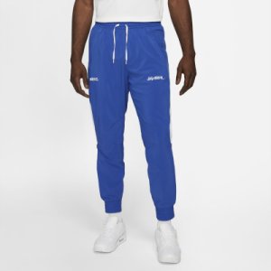 Męskie dresowe spodnie piłkarskie z tkaniny Nike F.C. - Niebieski