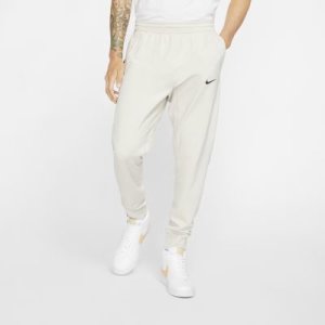 Męskie spodnie z dzianiny Nike Sportswear Tech Pack - Kremowy