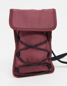 ASOS DESIGN cross body bag in burgundy with bungee cord detail-Red