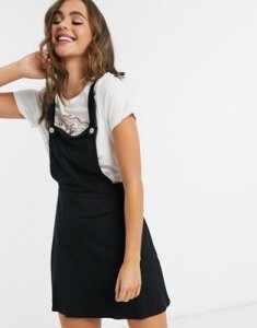 ASOS DESIGN mini pinafore skirt with buttons in black