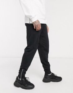 ASOS DESIGN organic tapered sweatpants in black with silver zip cuffs