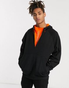 ASOS DESIGN oversized hoodie in black with half zip and orange inserts