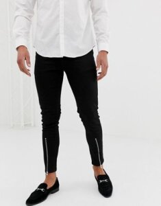 ASOS DESIGN skinny jeans with zipped hem detail in black