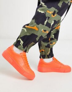 ASOS DESIGN sneakers in neon orange