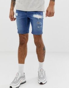 ASOS DESIGN spray on denim shorts in power stretch mid wash blue with heavy rips