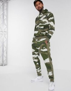 Nike Club Essentials cuffed sweatpants in camo print-Green