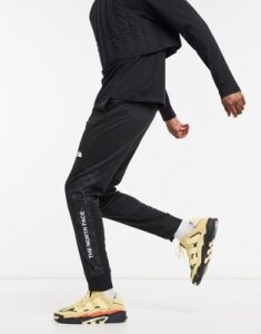 The North Face Train N Logo cuffed pants in black